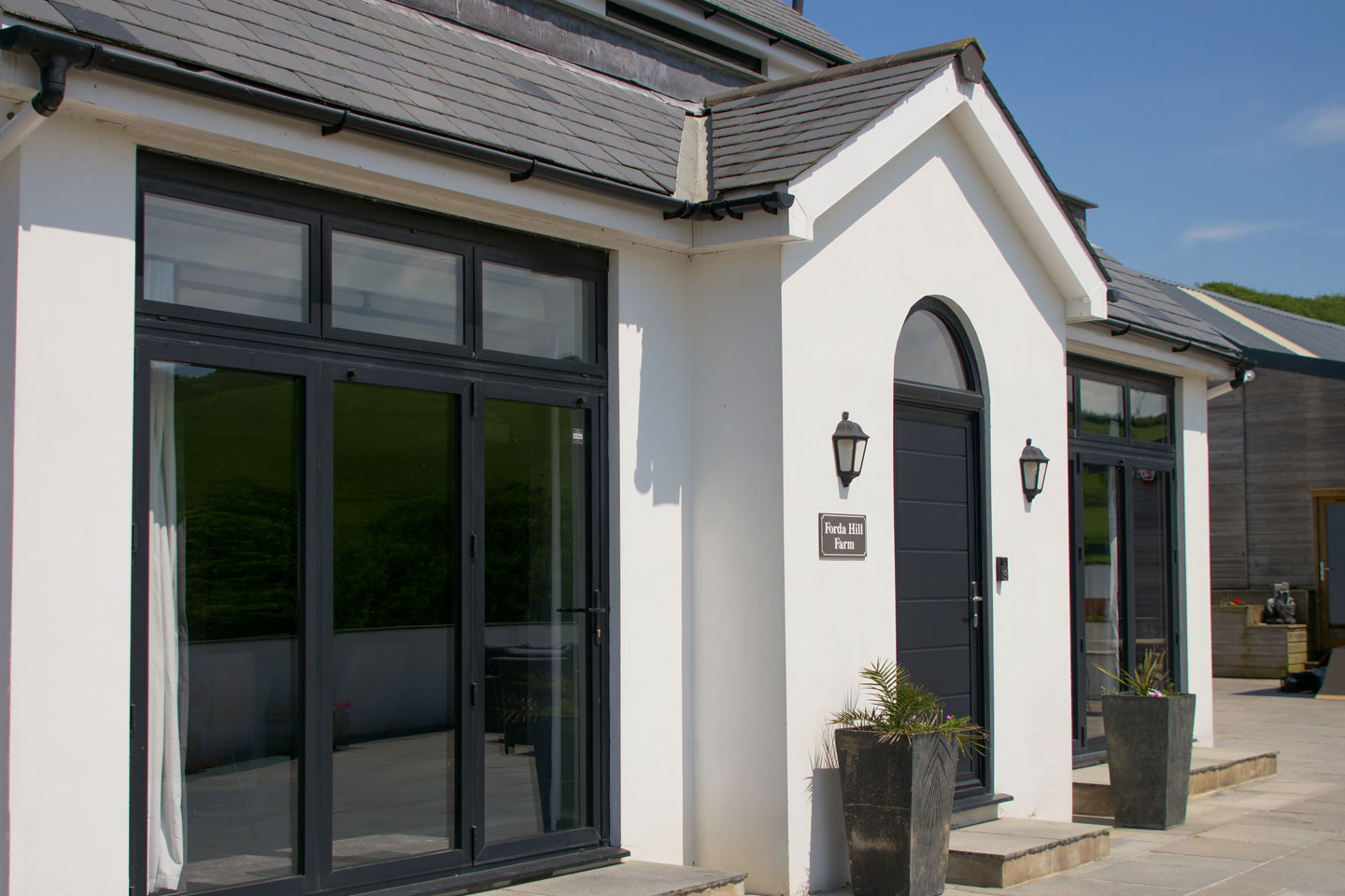 Aluminium Bi-Fold Doors and Front Door onto paving area