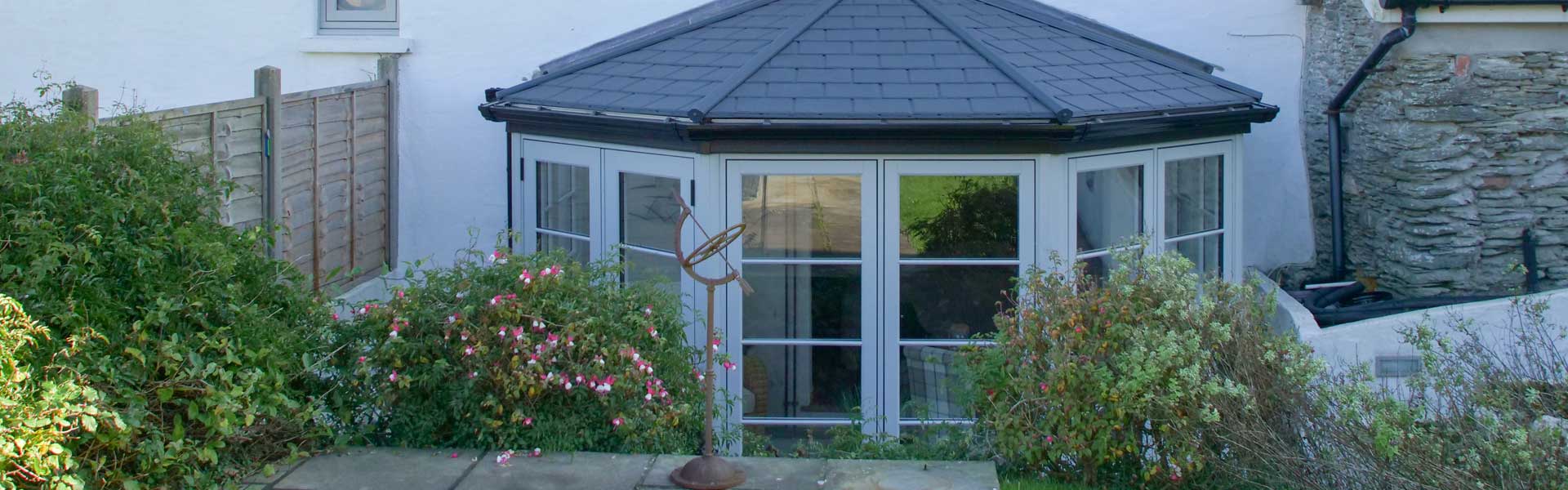 White framed Conservatory with a grey coloured tiled roof