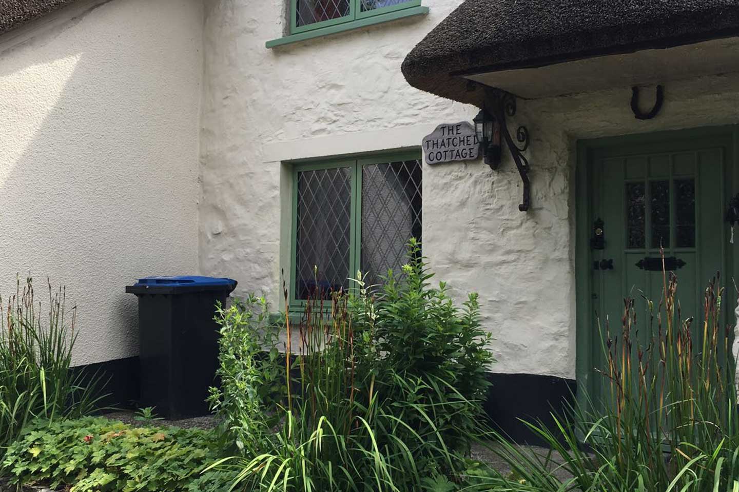 Green coloured Wooden Lingham Door in a Thatched Cottage