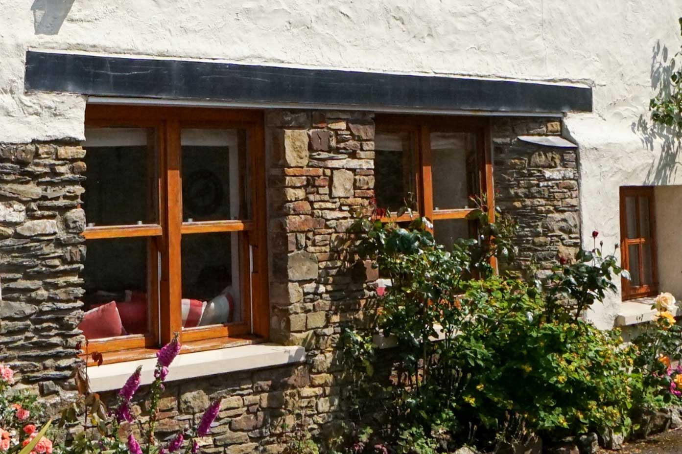 Wooden Windows on a traditional home with beautiful flowers
