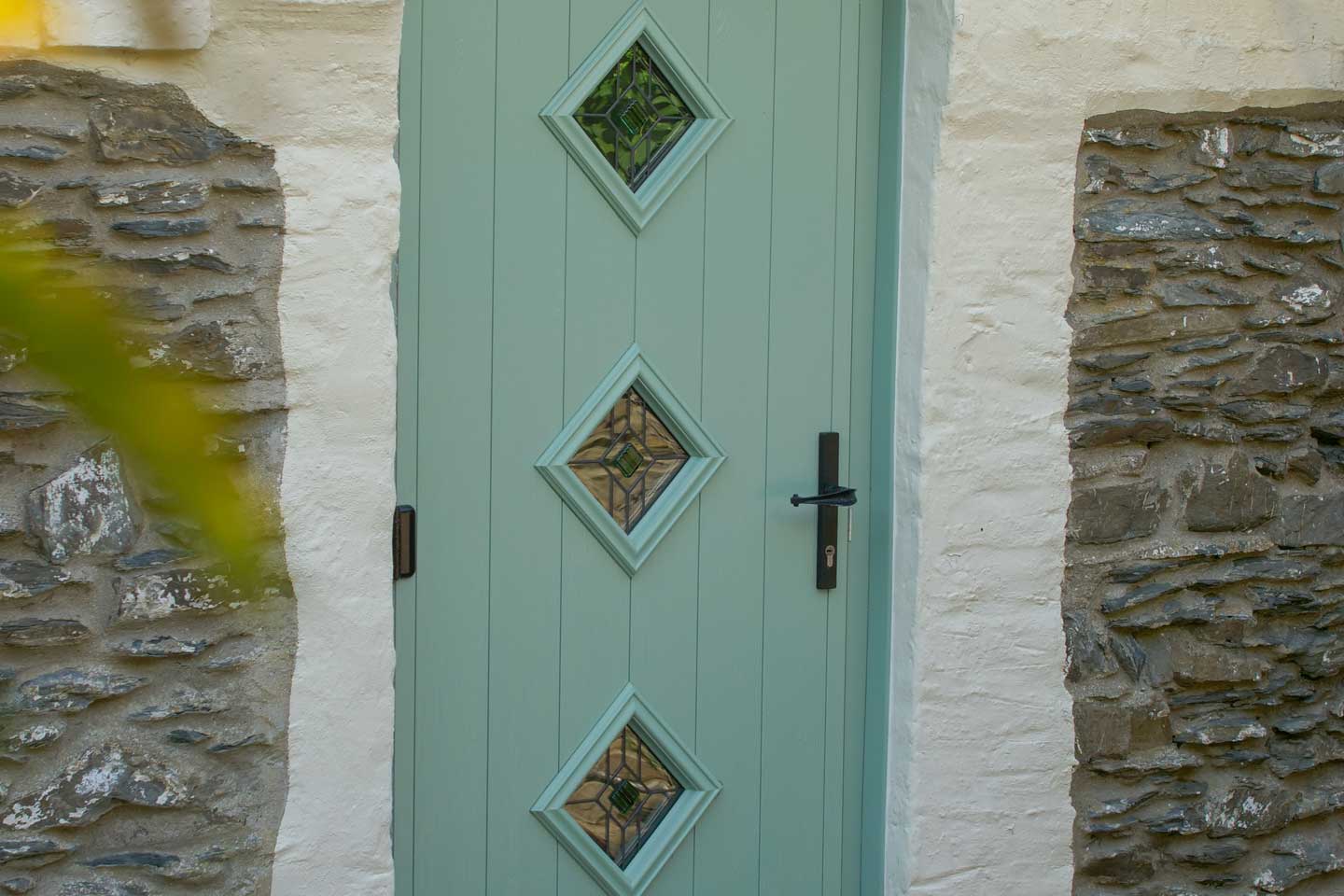 Green coloured Solidoor with diamond shaped glass panels
