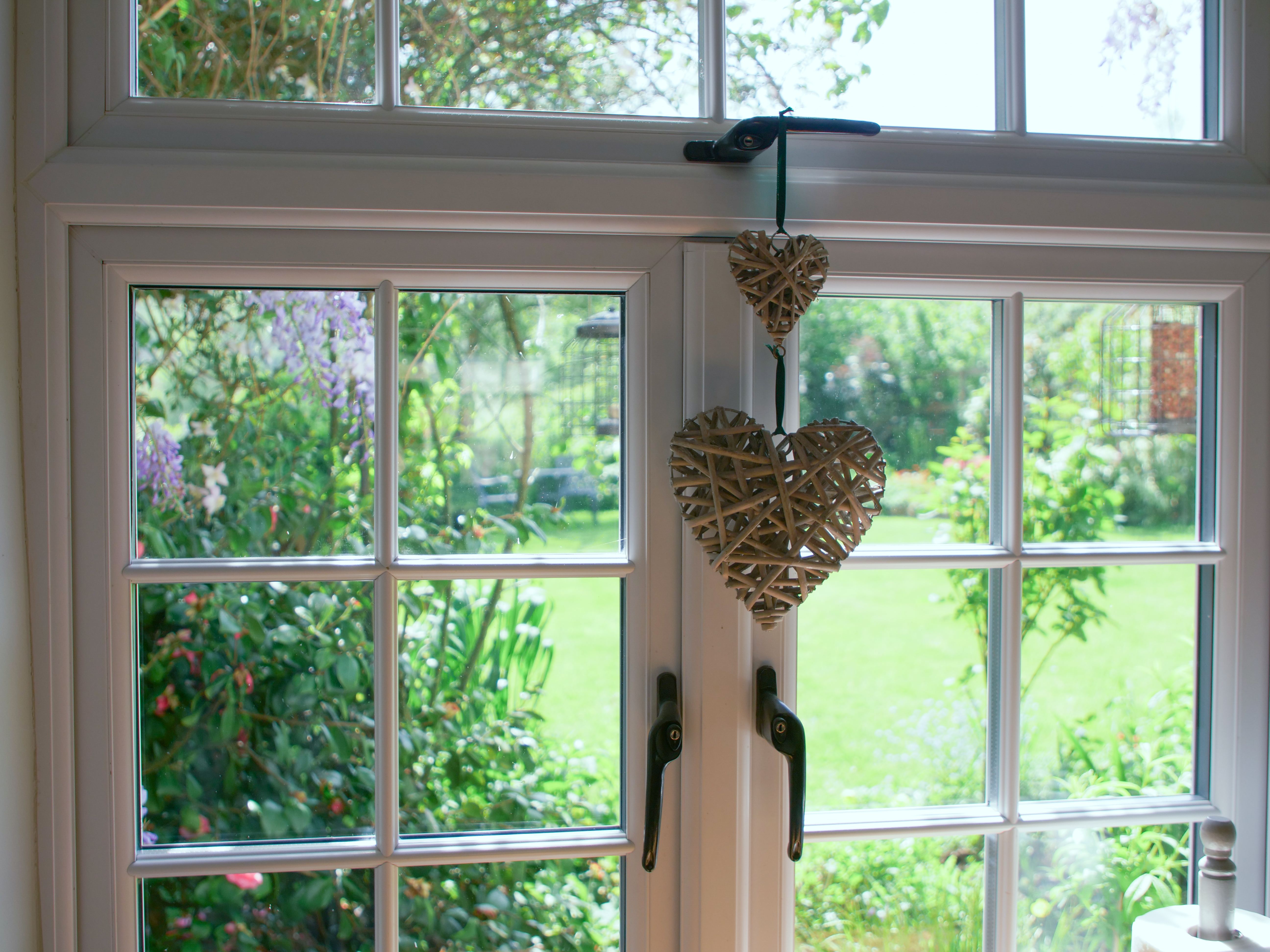 Casement window from the inside of a house looking out onto the garden