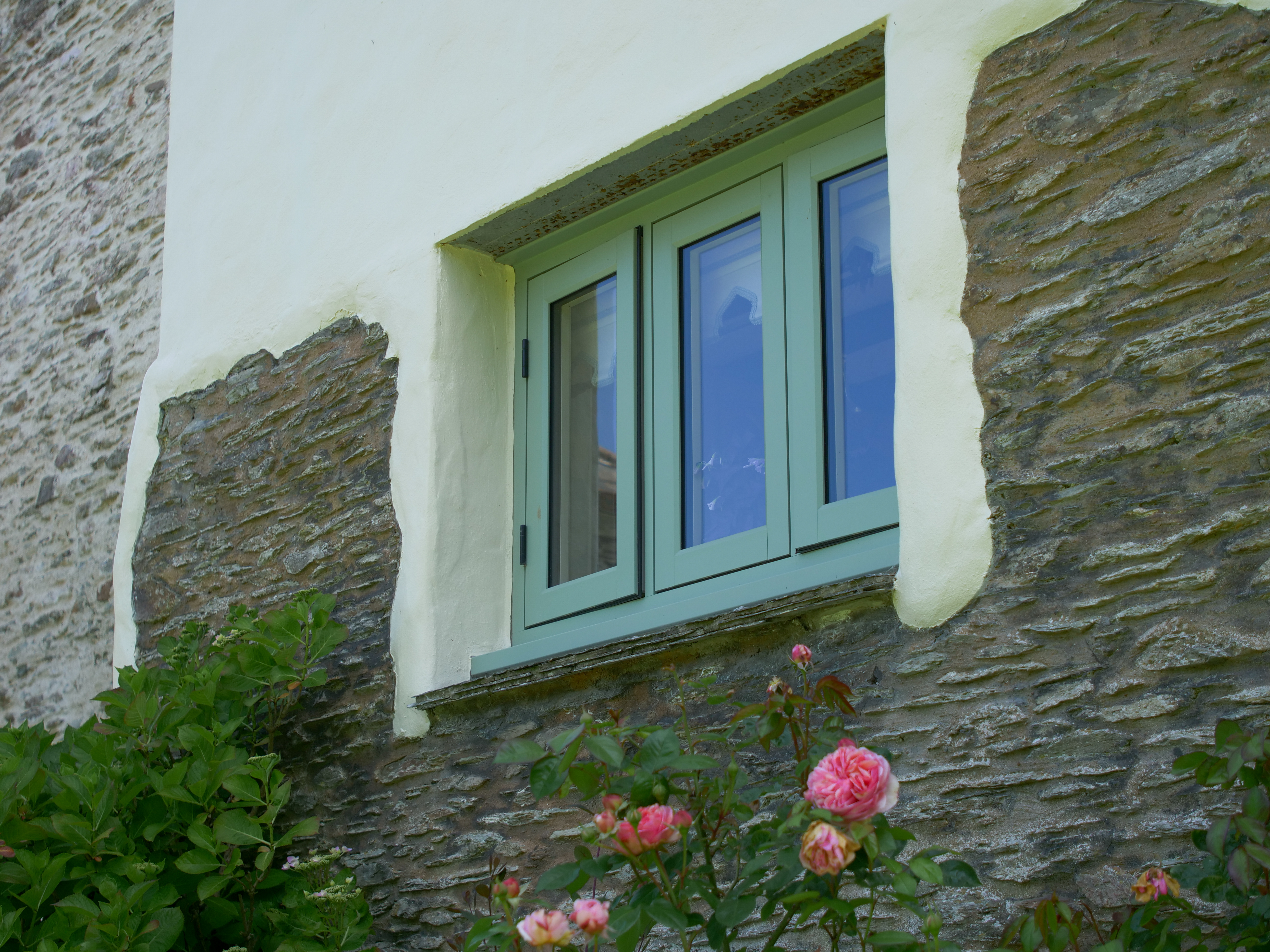 Close up of green coloured windows of a house