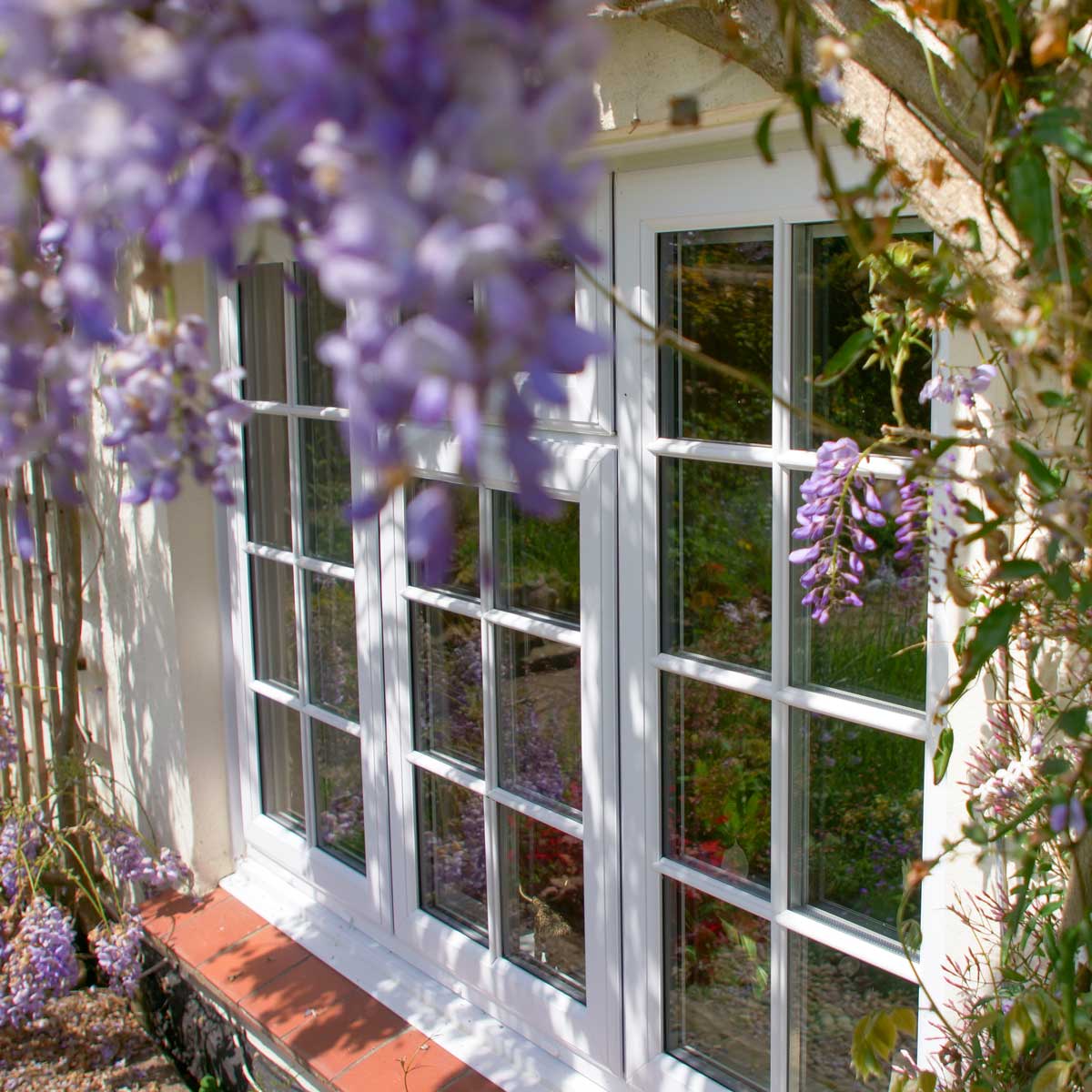 White uPVC Window surrounded by purple flowers