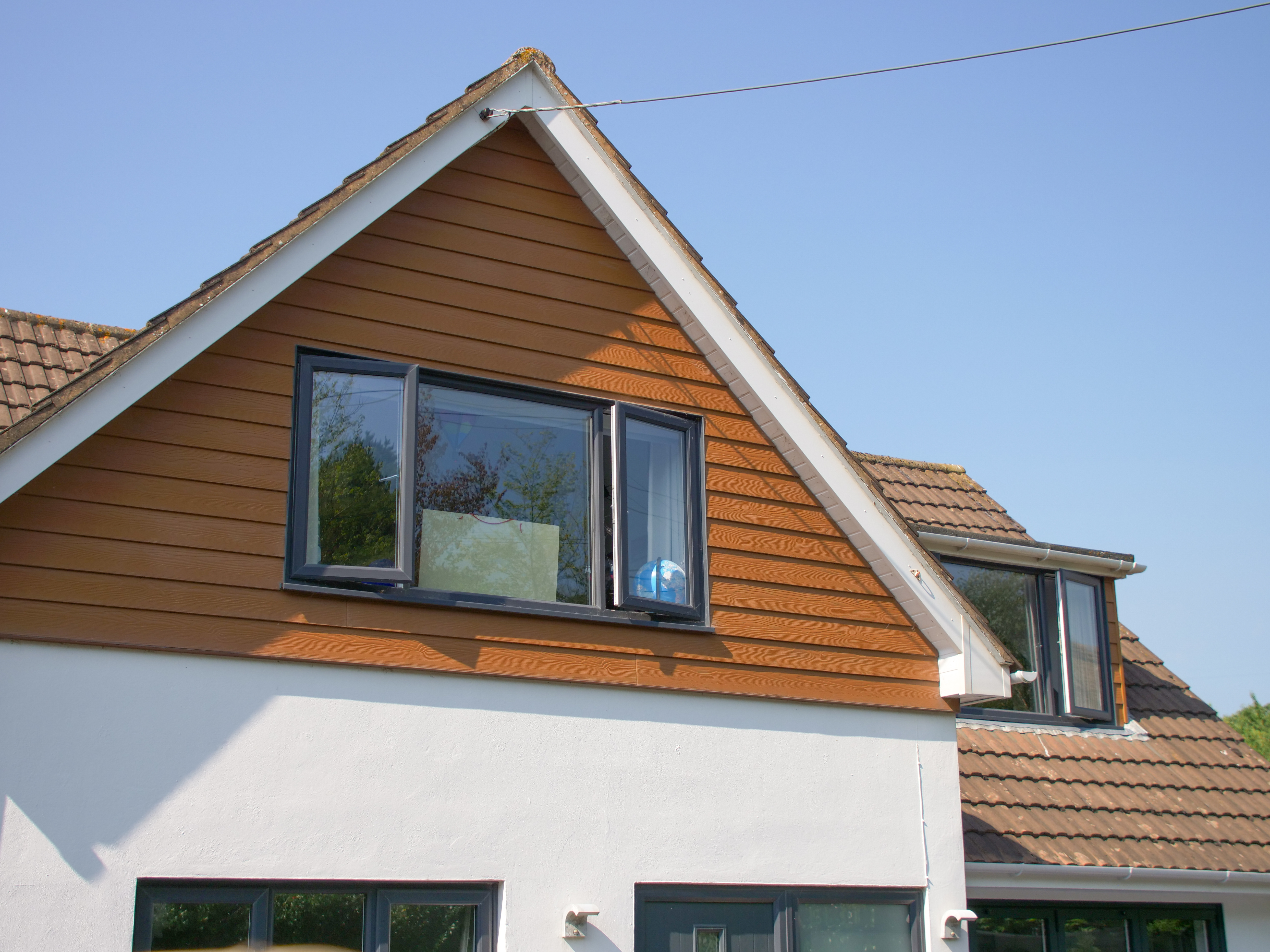 House roofline with external cladding and window