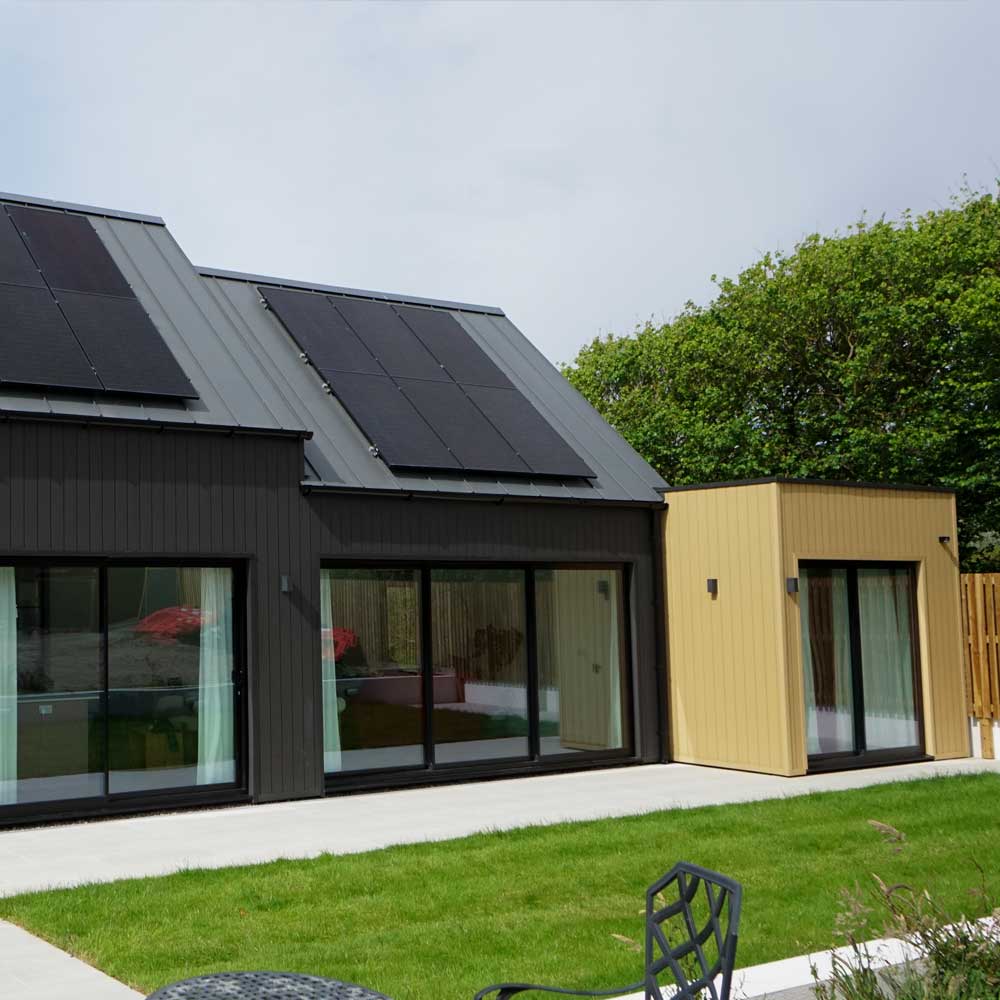 Dark grey Bi-Fold Aluminium Doors to the rear of a home