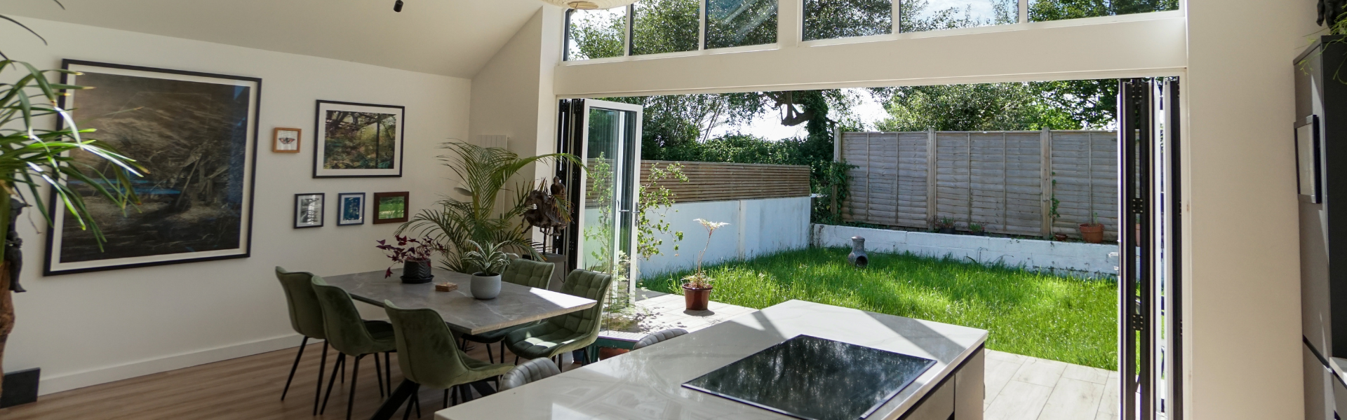 Interior View of Open Aluminium Bifold Doors looking from Kitchen to garden