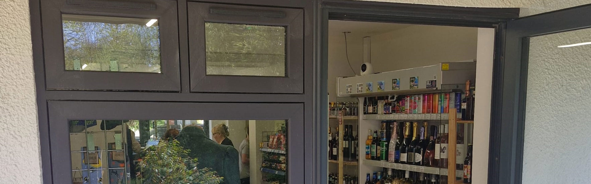 A shop doorway with dark grey aluminium doors