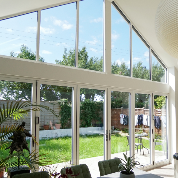 White Aluminium Bifold Doors interior looking into garden