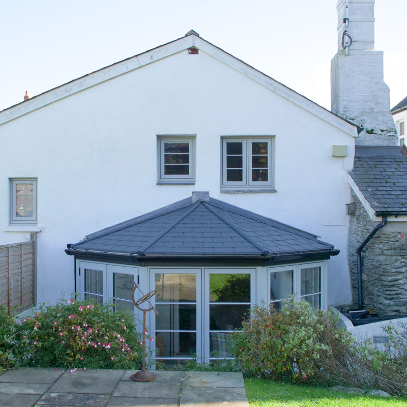 Dark grey coloured warm tiled roof fitted to a conservatory