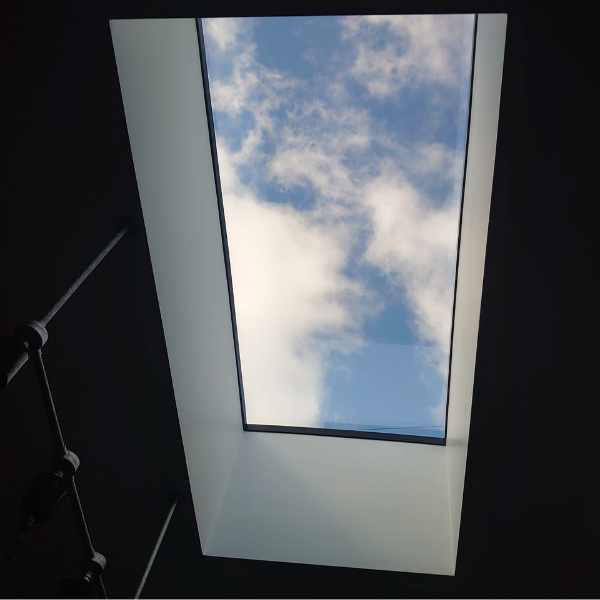 Interior of Flat Roof Light with blue sky and clouds