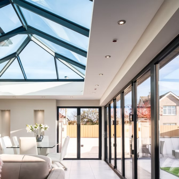 Interior of room with lantern roof system and bifold doors