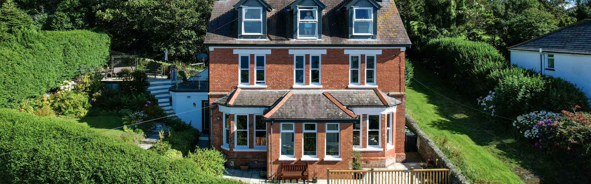 White coloured sash windows fitted to a large house