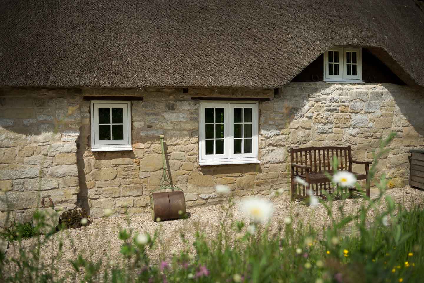 Traditional stone built home featuring Residence collection 9 windows