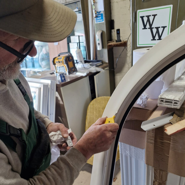 Man repairing a window frame