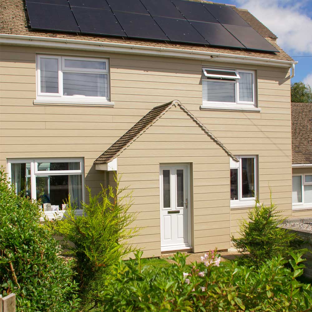 White coloured uPVC residential door to the front of a cladded home