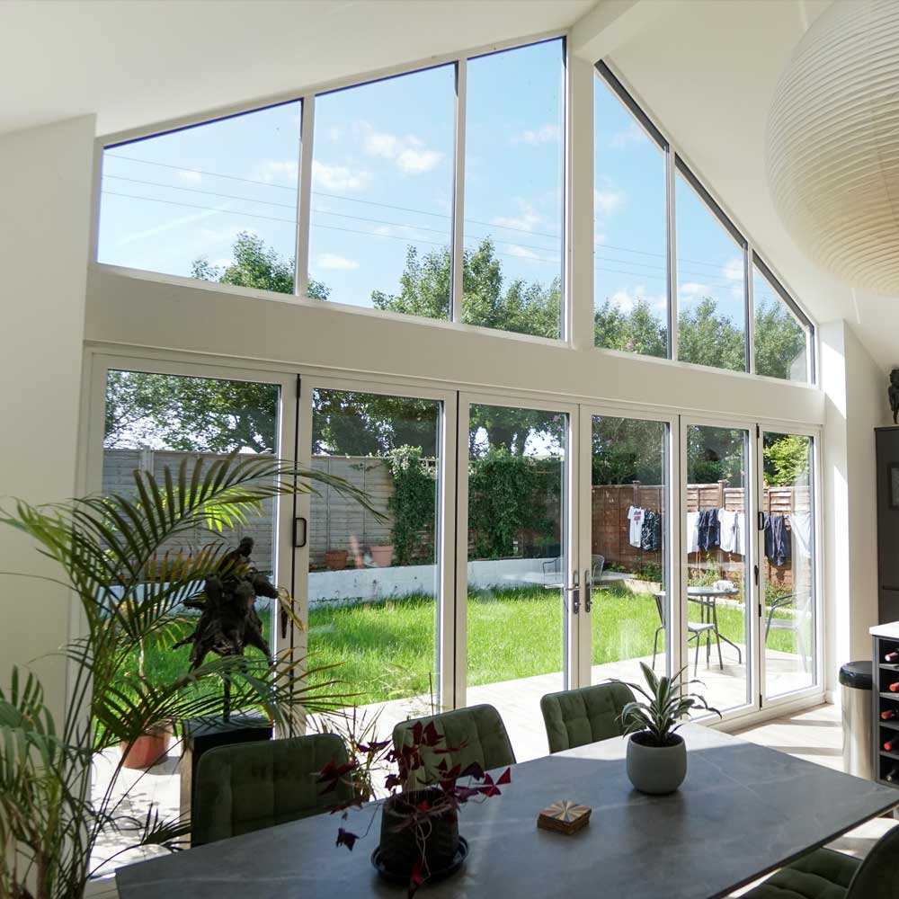 White coloured Visoglide Slimline Bifold Doors and kitchen area of a home