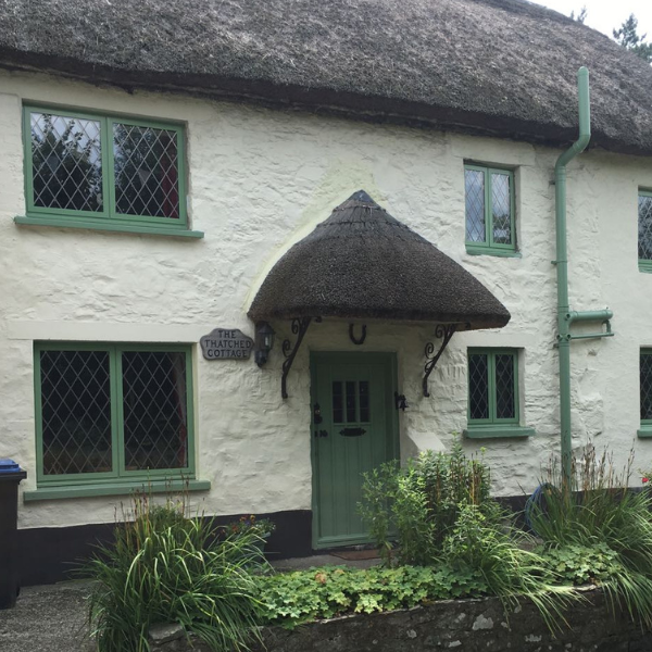 Green Wooden Windows on thatched cottage