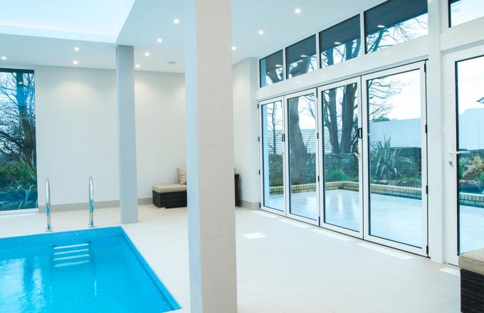 white bi fold doors for swimming pool from Woodstock