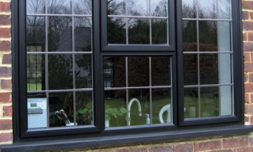 Black framed window with lead panes