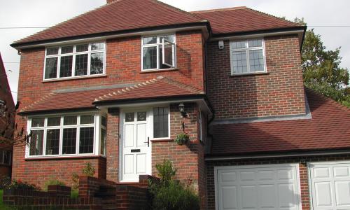 casement windows on a red house