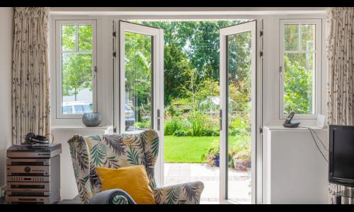 windows and doors leading to a garden
