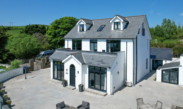 Front elevation of a house with aluminium windows and grey coloured door