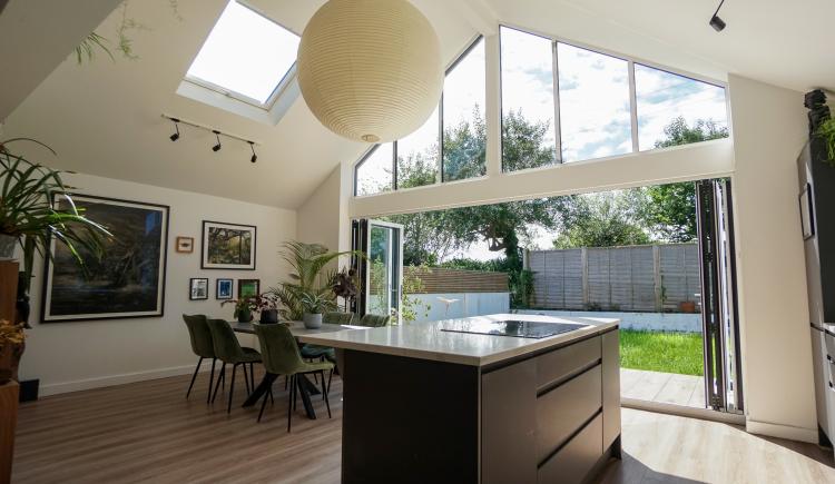 Interior of a kitchen with large patio doors opening onto garden