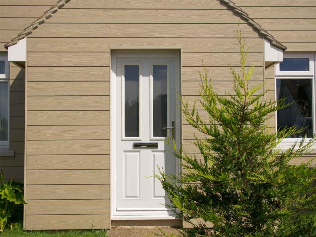 Solidoor front door to a house with cladding