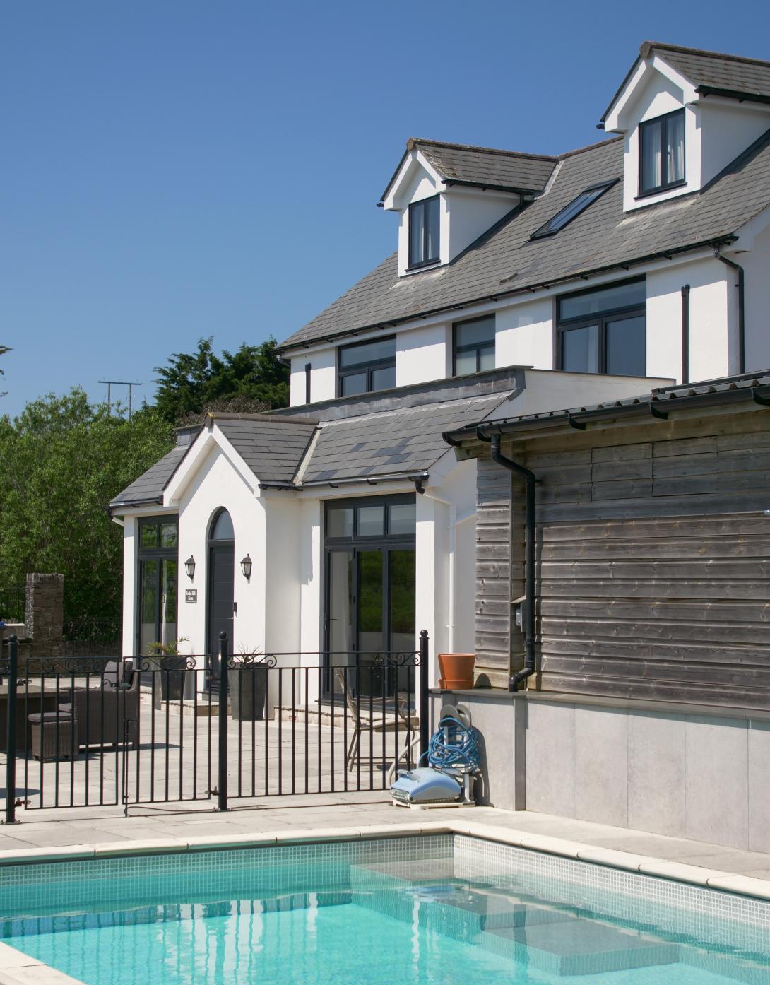Swimming pool and house featuring Smarts Aluminium Windows