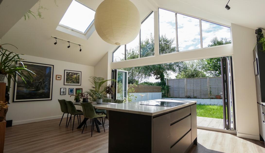 Interior of a kitchen with large patio doors opening onto garden