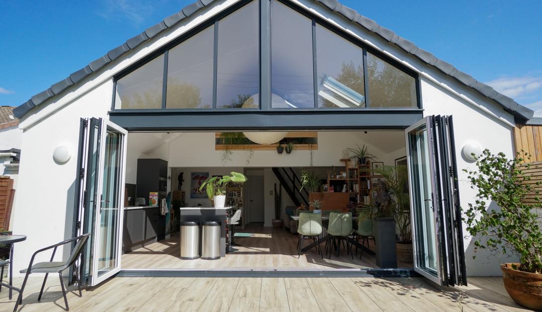Open grey coloured patio doors looking into kitchen area of a house