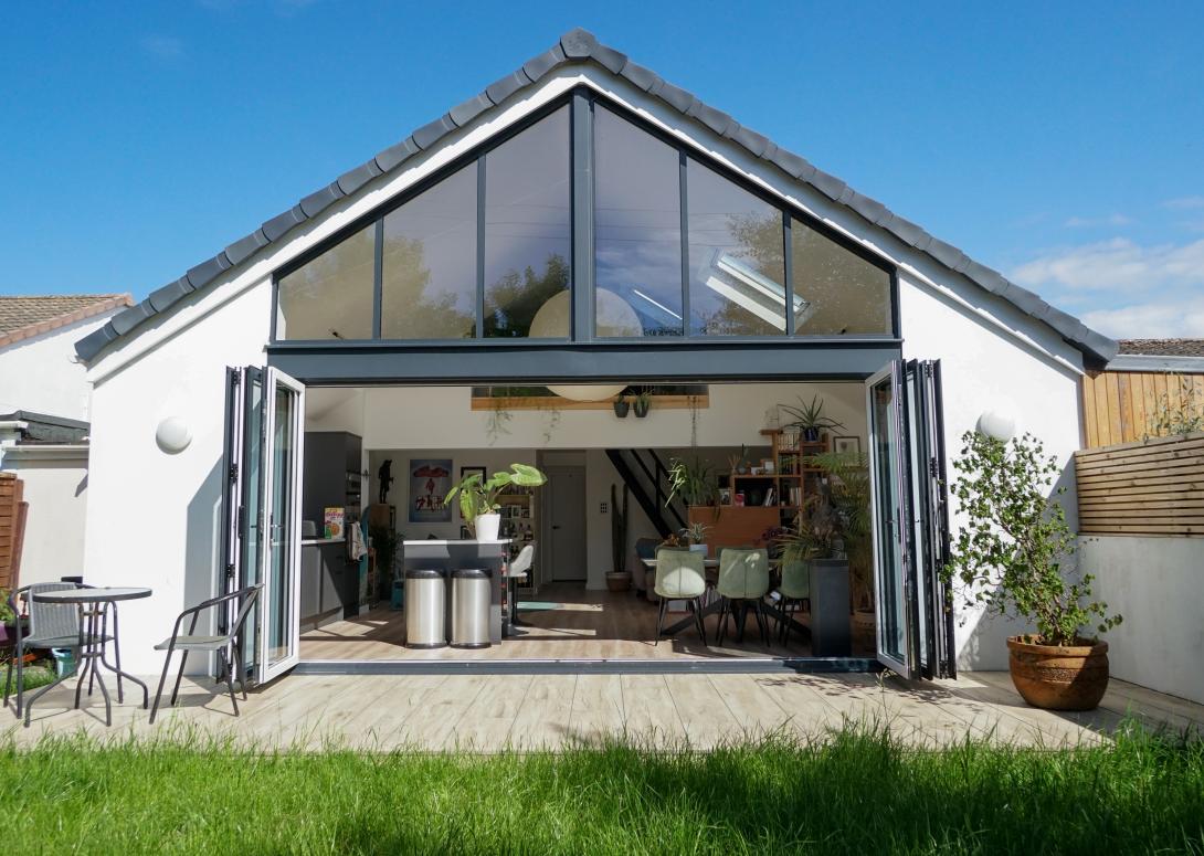 Open grey coloured patio doors looking into kitchen area of a house