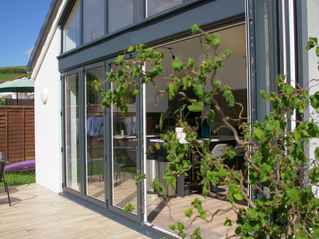 Close up shot of grey coloured exterior and white coloured interior patio doors and window