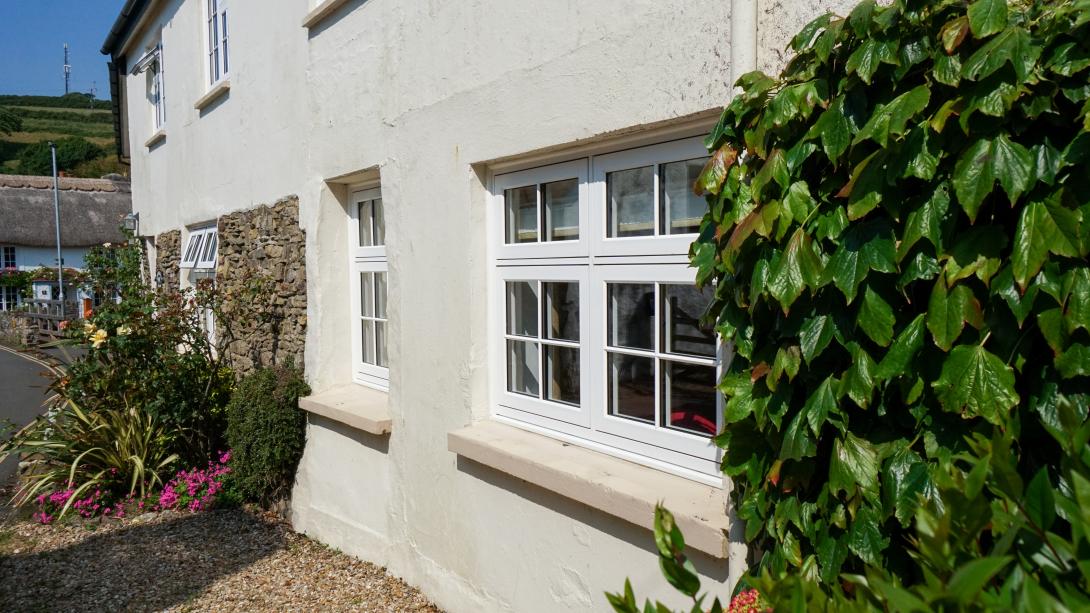 Roadside cottage with white coloured windows