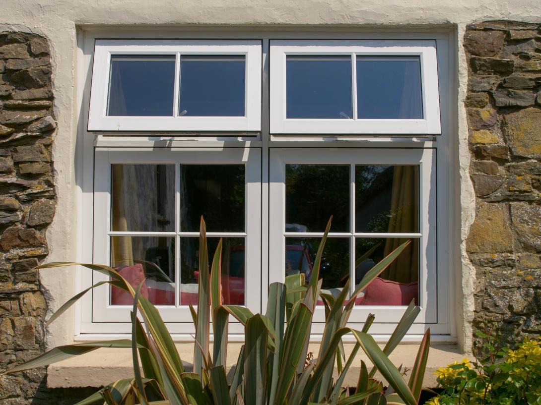 White framed window of a cottage