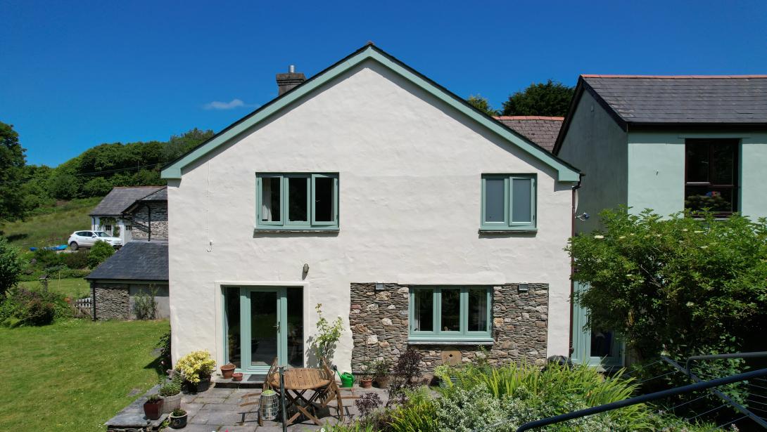 Green coloured windows and door to a patio area