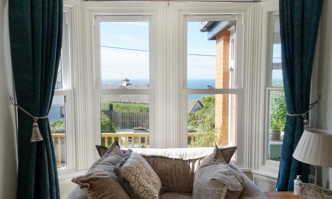 Interior view of white coloured uPVC sliding sash bay windows