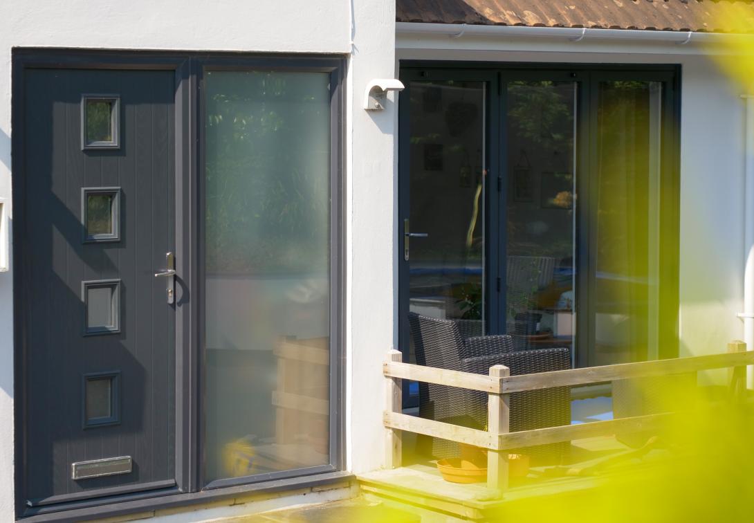 A grey coloured composite Solidor front door fitted by Woodstock Windows