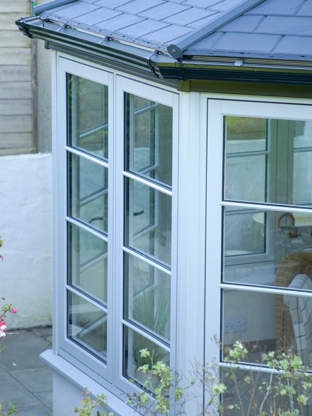 Conservatory featuring Residence 7 side frames and a solid Ultraroof warm core roof featuring slate-effect tiles