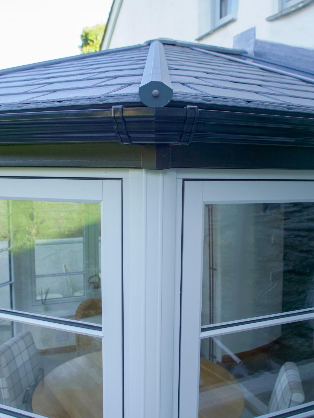 Conservatory featuring Residence 7 side frames and elegant French doors and a solid Ultraroof warm core roof featuring slate-effect tiles